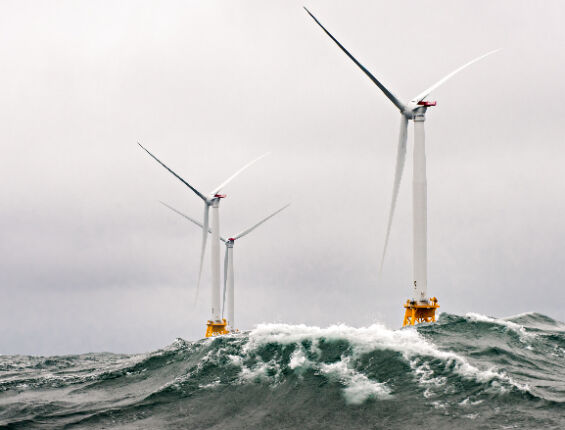 a group of wind turbines in the ocean