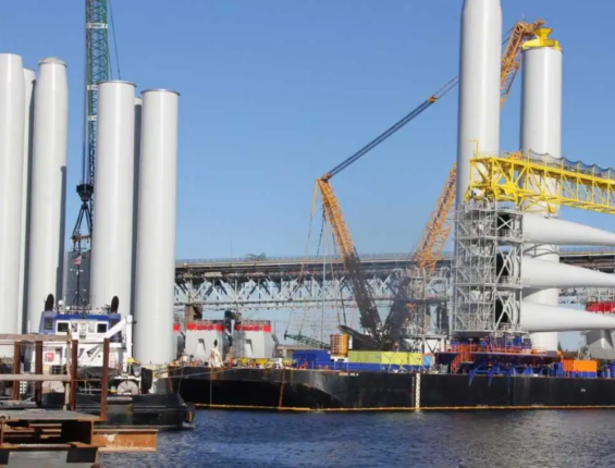 wind turbine construction materials sitting on ships in the ocean